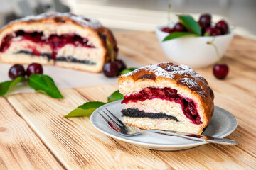 American pie on plate on rustic wooden board with full cake and sweet cherry berries on background. Easy recipe of cherry cake, vegan dessert gluten free. Homemade bakery with flaky crust.