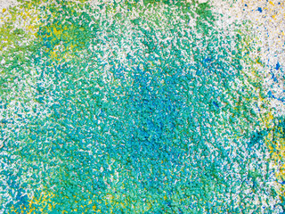 Juicy abstract background. Concrete grainy surface is covered with blue, yellow and green paint.