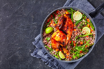 Roasted Half Chicken with brown rice in a skillet