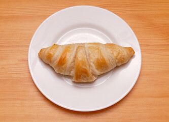 Baked crispy croissant on plate