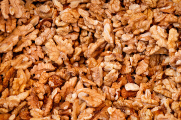 Raw walnuts outside of shell pile background pattern