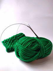 knitting needles and green threads
