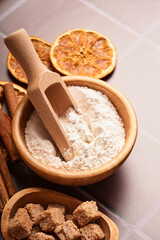 Baking background with ingredients for making gingerbread flour, eggs, kitchen tools, utensils and cookie molds on light brown wooden table. Mock up. Christmas baking.
