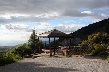 Wooden gazebo on the mountainside. There is a sea in the distance. View of Mount Olympus (Pieria, Greece).