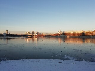 Naklejka premium Yekaterinburg, Russia - November 01 2021: View of buildings in Yekaterinburg city at the center. Iset river at winter time in sunny day