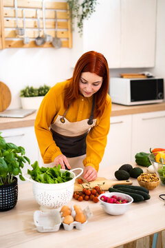 Woman preparing food while standing at table