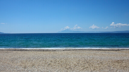 Empty coast of the sea. Beautiful view of the calm blue water. A place for quiet rest and relaxation.