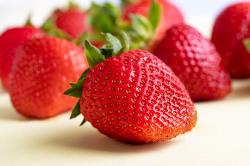 Strawberries on a yellow background. A sample of berries. Large strawberries