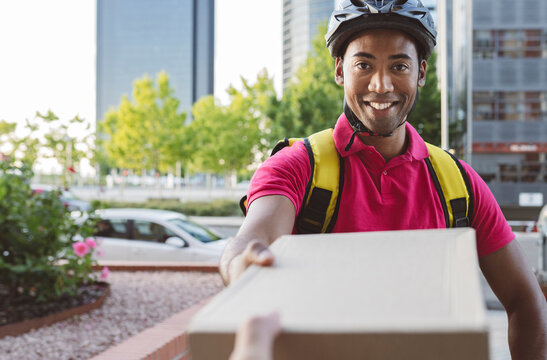 Male delivery person delivering package to customer