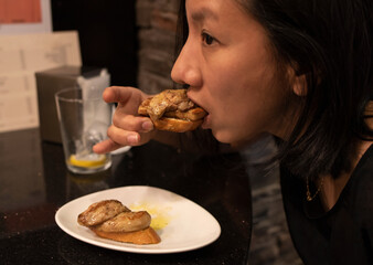 woman eating a foie snack