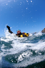 Male scuba diver in extreme panic at surface.