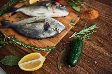 sea fish fresh ingredients lemon on wooden board