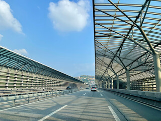 Como, Switzerland, 23.10.2021. Traffic on Swiss highway with noise barrier close to border crossing...