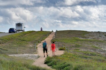 Obraz premium People,walking along the wild coast at the Quiberion peninsula in Brittany France