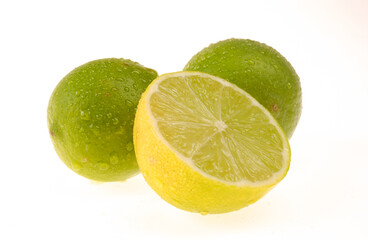 Lemons being one cut in half on white background.