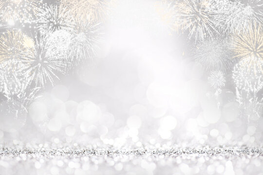 Silver fireworks and bokeh in New Year eve, copy space. Abstract background holiday