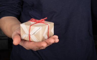 give gifts for the christmas holiday, paper box with a surprise in hand