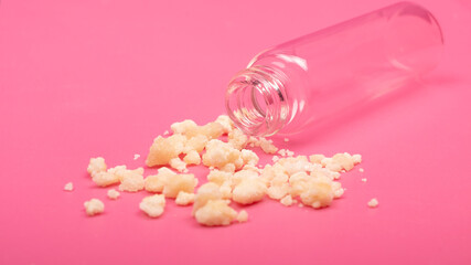 marijuana crystals close up, pieces of medical cannabis wax on pink background
