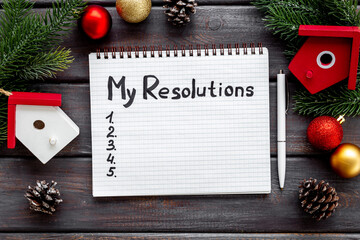 Resolutions hand writing list in notepad - inspirational and motivating concept