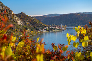 Naklejka na ściany i meble Beautiful autumn landscape with colorful grapevines, viewpoint over the beautiful village of Dürnstein, Wachau, Austria