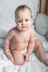 Child 1 year old on bed close-up..