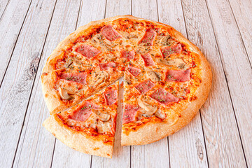 Family-size pizza with cooked ham, mozzarella cheese, oregano and sliced mushrooms