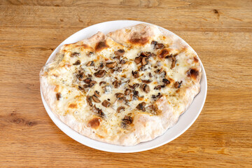Family-size pizza with cooked ham, mozzarella cheese, oregano and sliced mushrooms