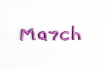 Fototapeta na wymiar The word March is made of lilac plasticine on a white background