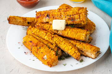 Corn grilled in barbecue spices with butter close-up. Corn ribs.