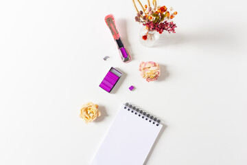 Open stapler with colored staples. Flat lay, top view. Feminine office concept.
