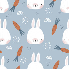 Cute hand-drawn childish seamless pattern with bunnies, carrots, rainbows and dots on a blue background. Texture with simple heads of hares. Ideal for fabric, textile, clothing, wrapping paper.