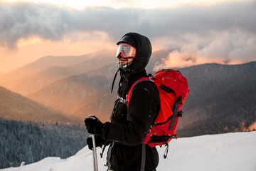 male ski rider against the backdrop of mountains and sky