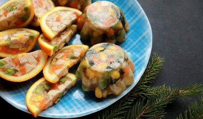 appetizer of jellied chicken with vegetables in orange close up selective focus