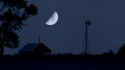 The moon rises over an abandoned farm in South Dakota.