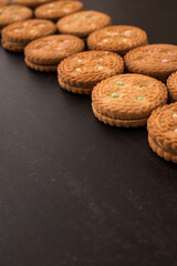 Some different cookies on a black wooden table 