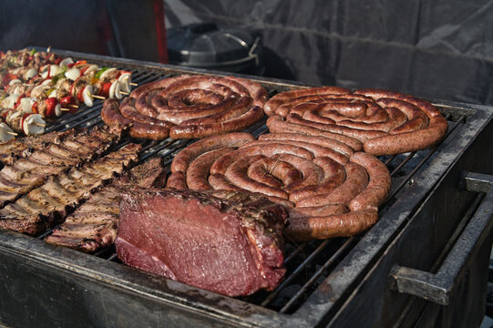 barbecue with meat, sausages and skewers