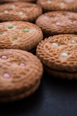 Some different cookies on a black wooden table 