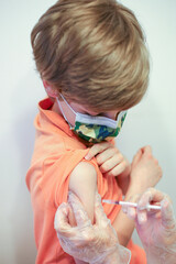 Chłopiec przyjmujący szczepionkę przeciwko Covid