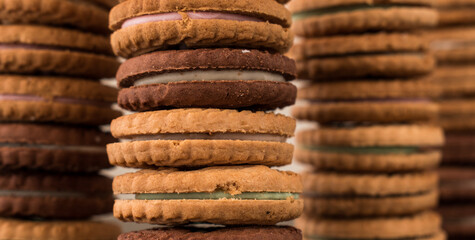 Different cookies one on top of the other on a black wooden table