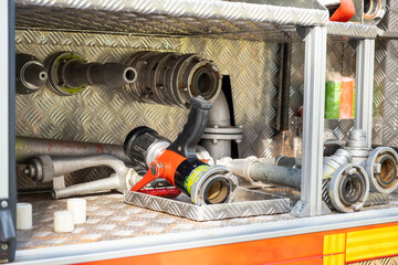 Different details of firefighting equipment ready to assemble in open truck metal body at contemporary station close view