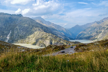 Obraz premium Traffic on the Grimsel Pass. The Grimsel Pass connects the Swiss cantons of Bern and wallis and is a watershed between the North Sea and the Mediterranean Sea