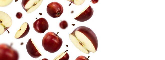 Flying red juicy apples and apples slices isolated on white background