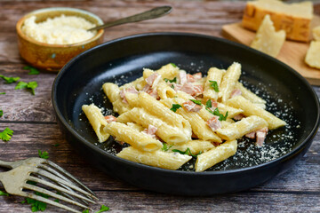  Fresh home made italian  penne  pasta   alla carbonara with  cream sauce  ,  bacon,egg, parmesan cheese ,olive oil and black pepper) 