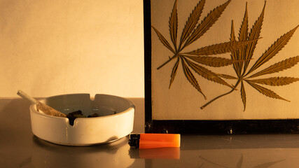 ashtray lighter and marijuana leaves
