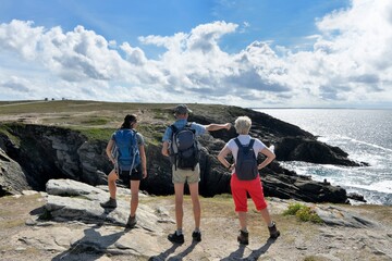 People,walking along the wild coast at the Quiberion peninsula in Brittany France