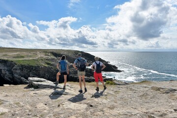 People,walking along the wild coast at the Quiberion peninsula in Brittany France