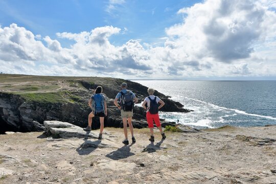 People,walking along the wild coast at the Quiberion peninsula in Brittany France - Powered by Adobe