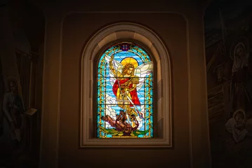 Deurstickers stained glass window with saint michael who kills a demon © Unia