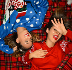 Two sisters laughing at christmas parties.