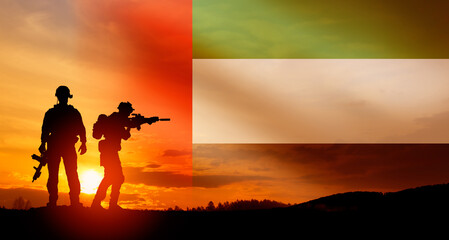 Silhouette of soldiers against the flag of UAE. Concept of national holidays. Commemoration Day.